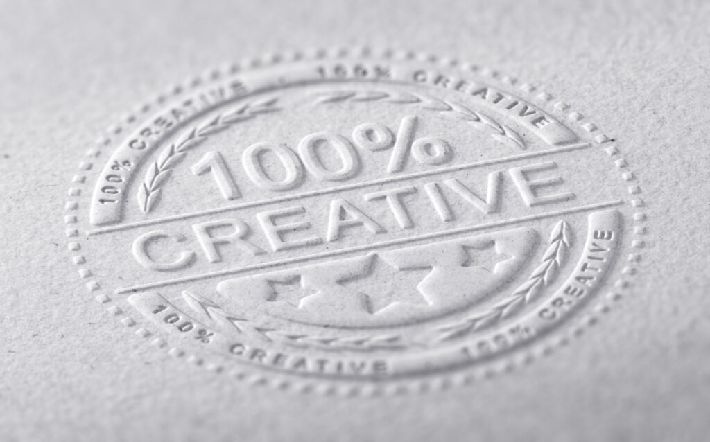 3D illustration of a stamp embossed on a paper texture with the text one hundred percent creative, horizontal image. Communication concept for creative advertising company